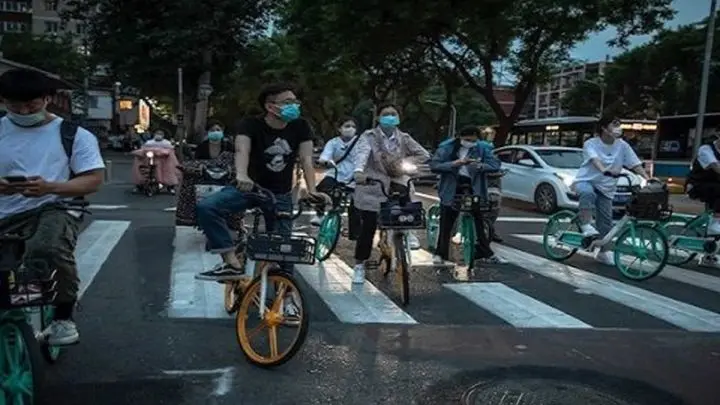 Personas en bicicleta tras desconfinamiento en China.