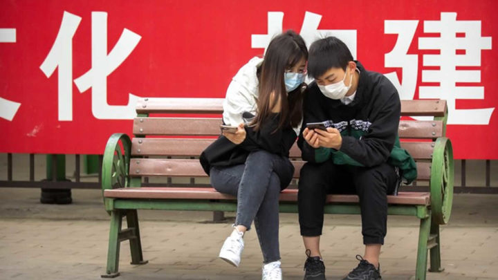Pareja con mascarilla en un parque público de Beijing, China