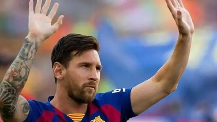 Messi levanta las manos en partido. 